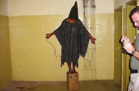 Prisoner connected to dummy electrical wires under threat that stepping down from the box would cause his electrocution 